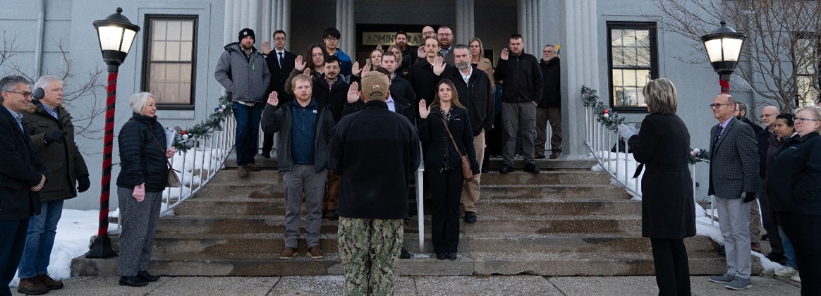 A group of new NSWC Crane employees takes the Oath of Office.